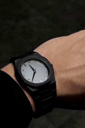 Aura men's watch with Arabic numerals and a matte black finish.